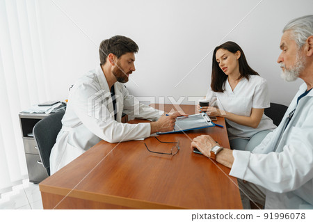 Successful medical doctors are discussing diagnosis during the conference Successful medical doctors are discussing diagnosis during the conference 91996078