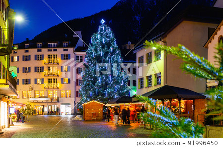 Night view of Brig street with Christmas tree on background of Alps, Switzerland Night view of Brig street with Christmas tree on background of Alps, Switzerland 91996450