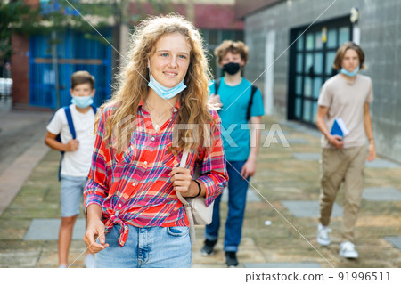 Teenager girl in mask going home after school Teenager girl in mask going home after school 91996511
