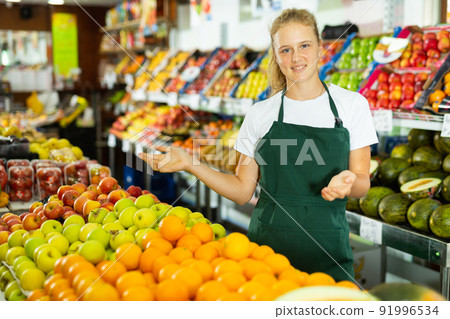 Portrait of a smiling girl who works part-time in a store as a trainee saleswoman Portrait of a smiling girl who works part-time in a store as a trainee saleswoman 91996534