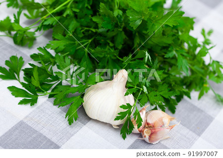 Garlic and parsley on the cutting board 91997007