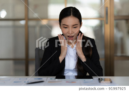 Portrait of Businesswoman surprise while checking turnover budget of company. Finance concept. Portrait of Businesswoman surprise while checking turnover budget of company. Finance concept. 91997925