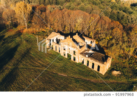 Bird's-eye view of ruins of the brewery in estate of the Tikhanovetskys. Aerial view of neo-gothic monument of industrial architecture of the early 20th century in autumn sunny day. Kanichi, Belarus 91997968