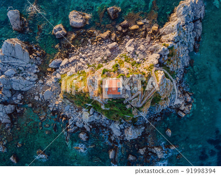 Sveta Nedelja is an islet on the Adriatic Sea, in Montenegrin municipality of Budva. It is located opposite the town of Petrovac na Moru in Montenegro. It has a small church on it 91998394