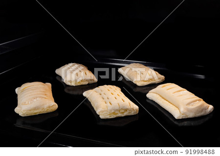 Five buns with ham, cheese baking in electric oven 91998488