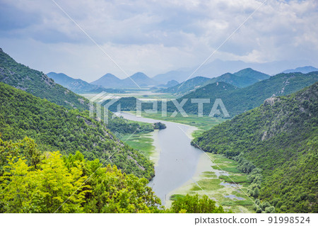 Canyon of Rijeka Crnojevica river near the Skadar lake coast. One of the most famous views of Montenegro. River makes a turn between the mountains and flows backward 91998524
