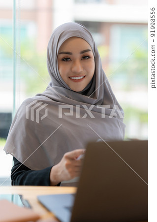 Business Finance audit tax Concept. Portrait of Muslim Young business women analytics about marketing plan of this years. 91998556