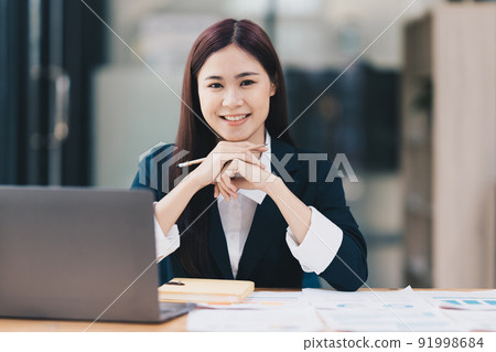 Business Finance audit tax Concept. Portrait of Asian happy Businesswoman smiling and working at office. Business Finance audit tax Concept. Portrait of Asian happy Businesswoman smiling and working at office. 91998684