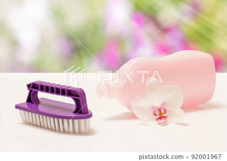 Bottle of dishwashing liquid and brush on blurred background. 92001967