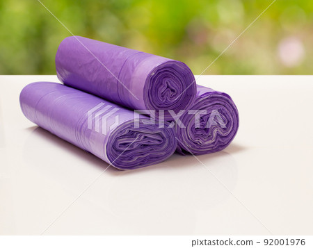 Rolls of garbage bags with blurred natural background. Rolls of garbage bags with blurred natural background. 92001976