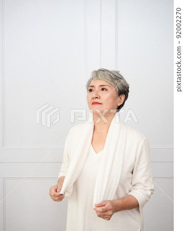 Portrait of mature 50s Asian woman wearing sports towel after exercise 92002270