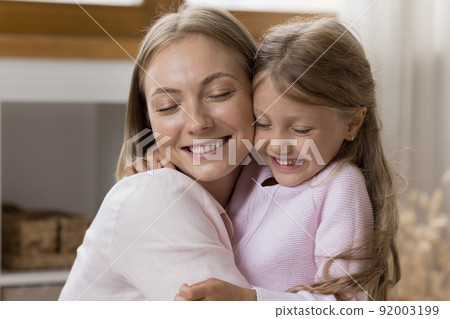 Happy loving mom hugging sweet little preschool daughter girl Happy loving mom hugging sweet little preschool daughter girl 92003199