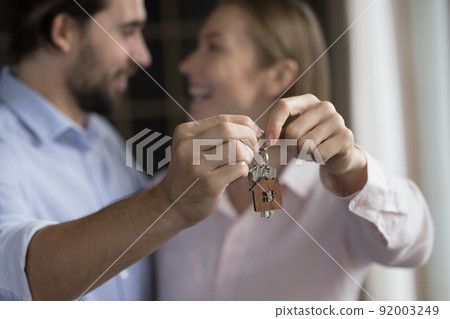 Happy couple of satisfied new homeowners celebrating relocation Happy couple of satisfied new homeowners celebrating relocation 92003249