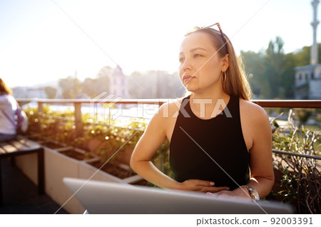 Young blonde businesswoman using laptop working at the terrace in Istanbul 92003391