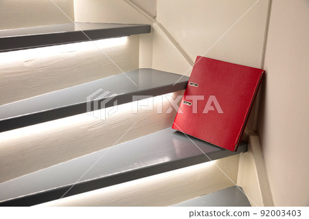 Red file on the stairs, selective focus Red file on the stairs, selective focus 92003403