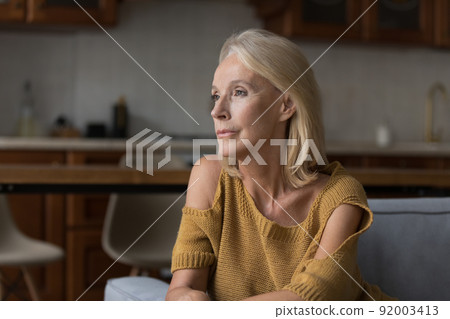 Thoughtful female in nostalgic mood thinking, looking into distance Thoughtful female in nostalgic mood thinking, looking into distance 92003413
