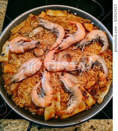 Paella with seafood in a pan. Top view 92003427
