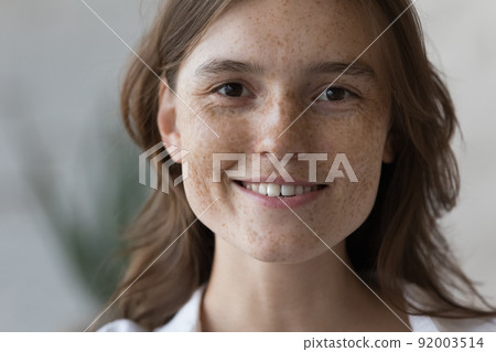 Portrait of freckled woman with natural beauty looking at camera Portrait of freckled woman with natural beauty looking at camera 92003514