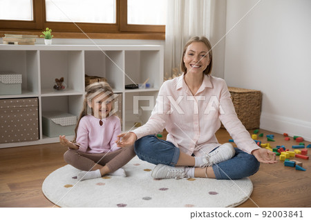 Happy joyful mom and kid feeling joy after meditating 92003841