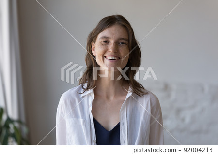 Woman with nice freckles on face smile staring at camera Woman with nice freckles on face smile staring at camera 92004213