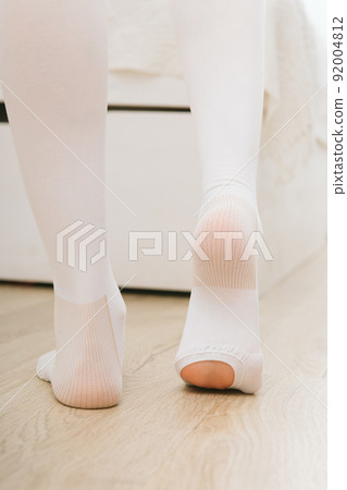 Anti-embolic Compression Hosiery for surgery isolated on white. Medical white stockings, tights for varicose veins and venouse therapy. Thrombo embolic deterrent hose or anti-embolism stockings. Anti-embolic Compression Hosiery for surgery isolated on white. Medical white stockings, tights for varicose veins and venouse therapy. Thrombo embolic deterrent hose or anti-embolism stockings. 92004812