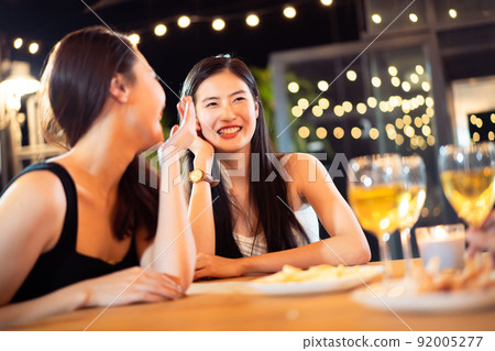 Happy Asian women enjoy celebrating a new year eve festival together with a lot of drink and food. New Year Eve party concept. Happy Asian women enjoy celebrating a new year eve festival together with a lot of drink and food. New Year Eve party concept. 92005277