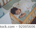 A baby who sleeps well in a crib 92005606