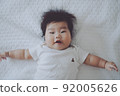 A baby with a happy expression in a good mood 92005626