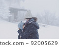 Parent and child in the snow of a blizzard 92005629