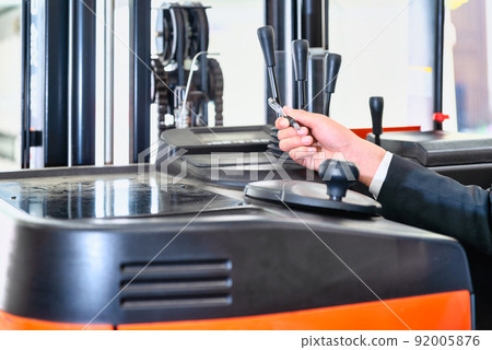 Image cut of a businessman who confirms the safety of a forklift Image cut of a businessman who confirms the safety of a forklift 92005876