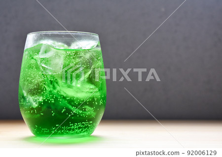 Melon soda poured into a round glass Melon soda poured into a round glass 92006129