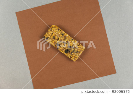 Protein Energy Bar on brown. A gluten-free, sugar-free snack. Oatmeal flapjack with fruit. Healthy Foods. Protein Energy Bar on brown. A gluten-free, sugar-free snack. Oatmeal flapjack with fruit. Healthy Foods. 92006575
