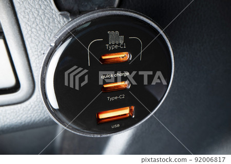 Close-up view of powerful car charger with USB type C and type A ports, shot with macro probe lens 92006817