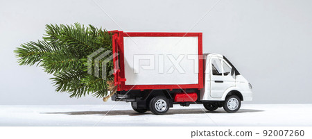 red cargo van carrying a christmas tree, banner format red cargo van carrying a christmas tree, banner format 92007260