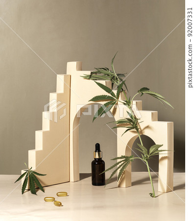 glass bottle with CBD oil, THC tincture and hemp leaves on a pastel background. minimalism. Cosmetics CBD. glass bottle with CBD oil, THC tincture and hemp leaves on a pastel background. minimalism. Cosmetics CBD. 92007331