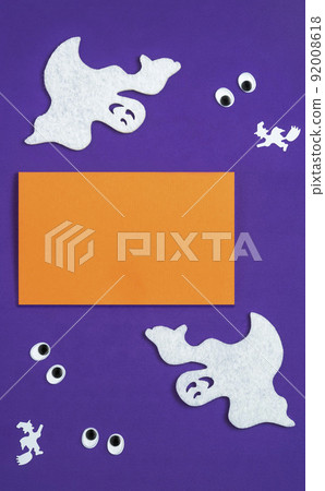 Abstract Halloween composition, background for halloween card, vertical banner. Text Boo,  silhouettes of ghosts and witches on a broomstick. Googly eyes 92008618