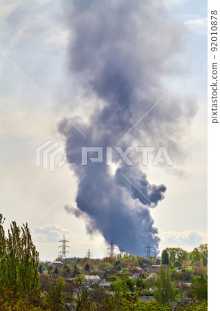 Burning tanks with fuel at the oil depot as a result of a rocket hit 92010878