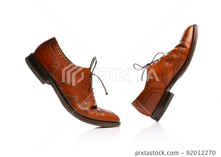 Male brown classic style shoes over white background. Vintage dress shoes. Concept of ad, sales , fashion, retro vintage style Male brown classic style shoes over white background. Vintage dress shoes. Concept of ad, sales , fashion, retro vintage style 92012270