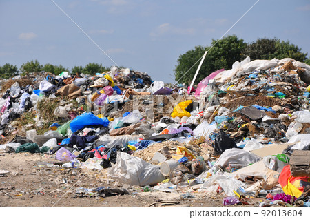 Different types of garbage mixed in one in a city landfill 92013604