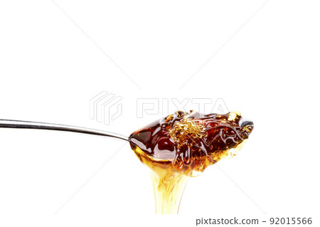 Tasty honey dripping from a teaspoon. Organic food 92015566