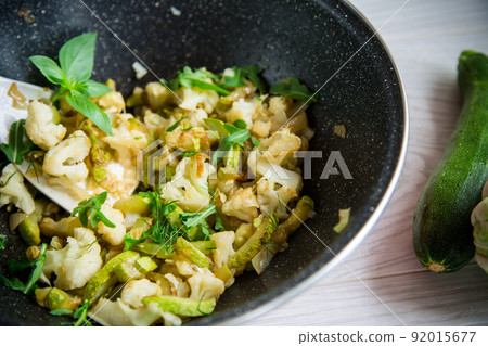 cauliflower fried with zucchini and vegetables in a pan cauliflower fried with zucchini and vegetables in a pan 92015677