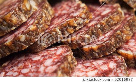 Chunks of dried sausage taken in close-up. Sausage full frame. Chunks of dried sausage taken in close-up. Sausage full frame. 92016987