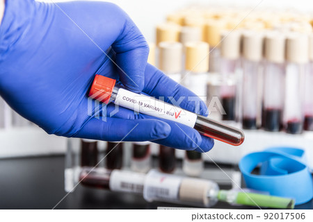 Doctor's hands hold blood samples of the new variant IHU, covid19, coronavirus. Selective approach to the sample tube. 92017506