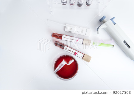 Blood samples of the new variant omicron plus flu FLURONA, covid19, coronavirus. Selective approach to the sample tube. 92017508