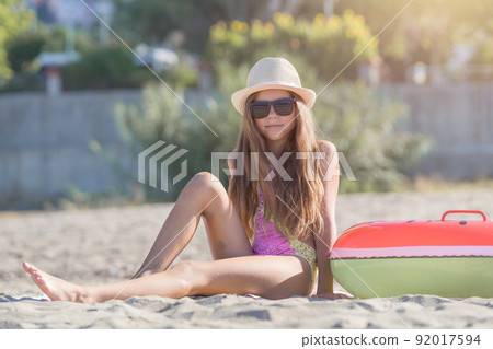 A teenage girl sits and enjoys Cleopatra Beach in Alanya, Turkey. A teenage girl sits and enjoys Cleopatra Beach in Alanya, Turkey. 92017594