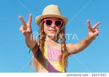 Happy girl with raised hands against the sky. Happy girl with raised hands against the sky. 92017607