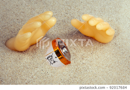 image of battery plastic hands sand background 92017684