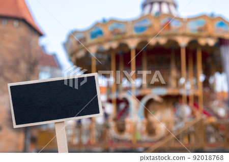 Empty mockup template Blackboard label against Carousel in amusement park. Old-fashioned merry-go-round carousel 92018768