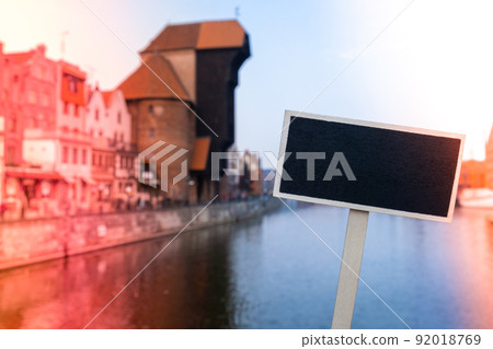 Empty mockup template Blackboard label against Gdansk beautiful old town over Motlawa river. The Zuraw Crane and colorful gothic facades of the old town in Gdansk, Poland. Visit Gdansk Travel to Empty mockup template Blackboard label against Gdansk beautiful old town over Motlawa river. The Zuraw Crane and colorful gothic facades of the old town in Gdansk, Poland. Visit Gdansk Travel to 92018769