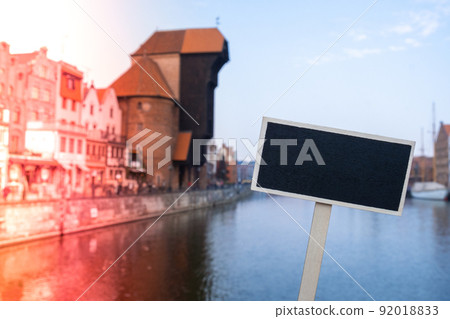 Empty mockup template Blackboard label against Gdansk beautiful old town over Motlawa river. The Zuraw Crane and colorful gothic facades of the old town in Gdansk, Poland. Visit Gdansk Travel to Empty mockup template Blackboard label against Gdansk beautiful old town over Motlawa river. The Zuraw Crane and colorful gothic facades of the old town in Gdansk, Poland. Visit Gdansk Travel to 92018833